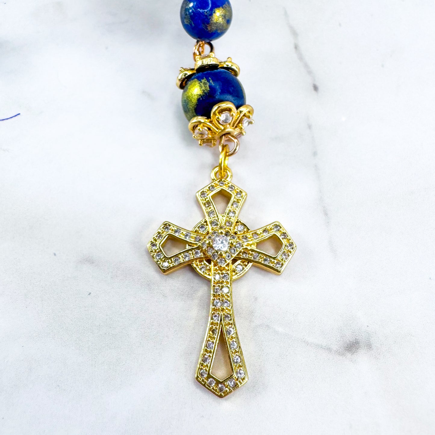 Luxury Catholic rosary bracelet handcrafted with natural Lapis Lazuli gemstone beads, a gold-tone cross with zirconia accents, and a Lady of Guadalupe medal. Adjustable beaded bracelet perfect for prayer, religious gifts, Confirmation, bridesmaid gifts, or everyday devotion. Made in Edmonton, AB, Canada.