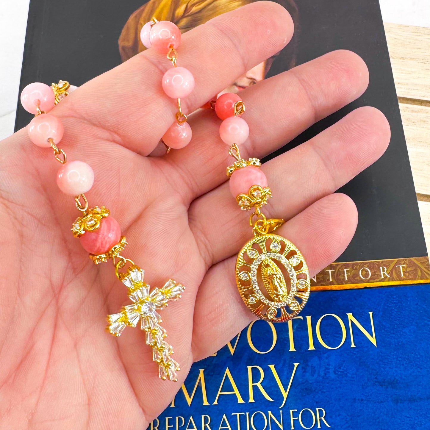 Luxury Catholic rosary bracelet handcrafted with natural pink persian jade gemstone beads, a gold-tone cross with zirconia accents, and a Lady of Guadalupe medal. Adjustable beaded bracelet perfect for prayer, religious gifts, Confirmation, bridesmaid gifts, or everyday devotion. Made in Edmonton, AB, Canada.