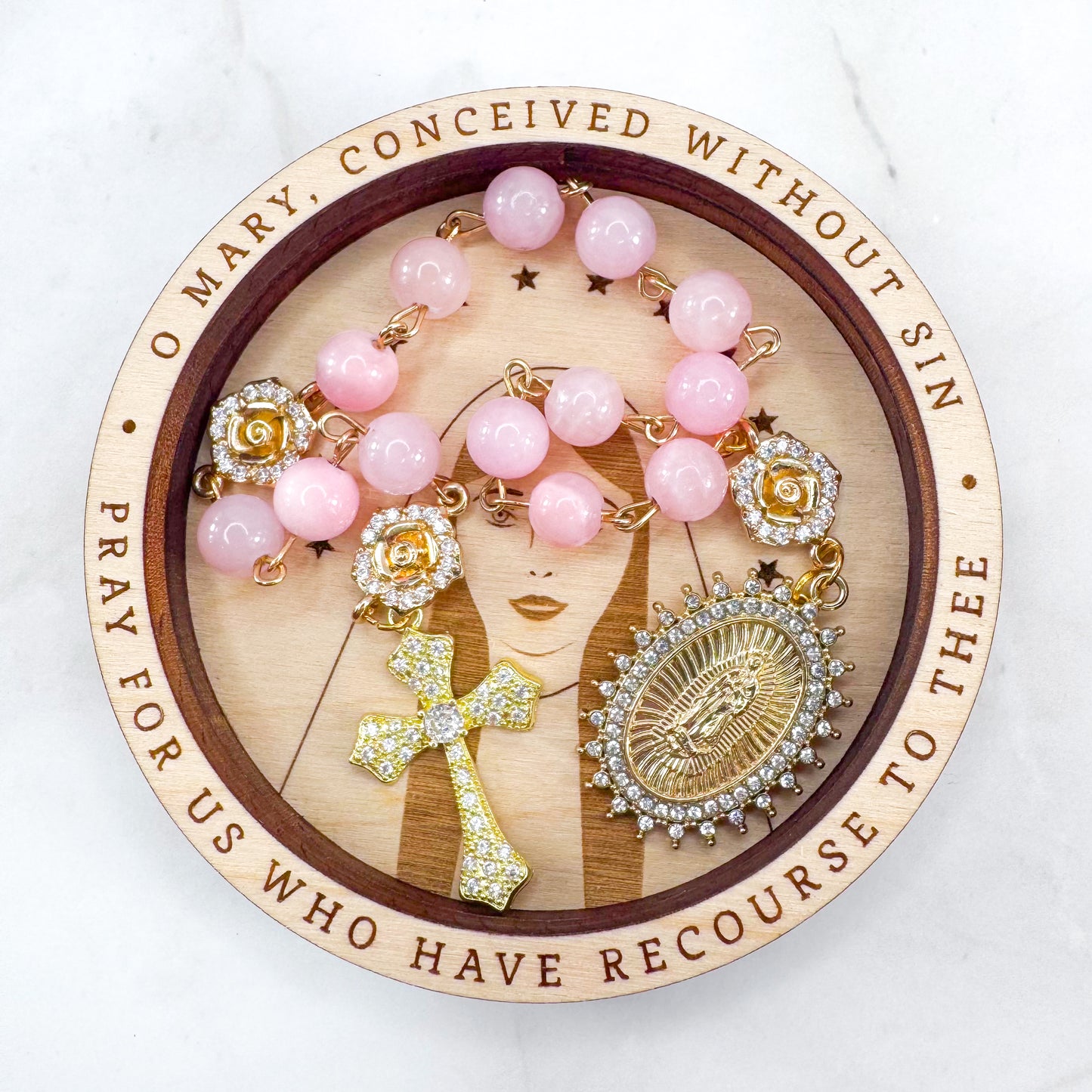 Luxury Catholic rosary bracelet handcrafted with natural rose quartz gemstone beads, a gold-tone cross with zirconia accents, and a Lady of Guadalupe medal. Adjustable beaded bracelet perfect for prayer, religious gifts, Confirmation, bridesmaid gifts, or everyday devotion. Made in Edmonton, AB, Canada.