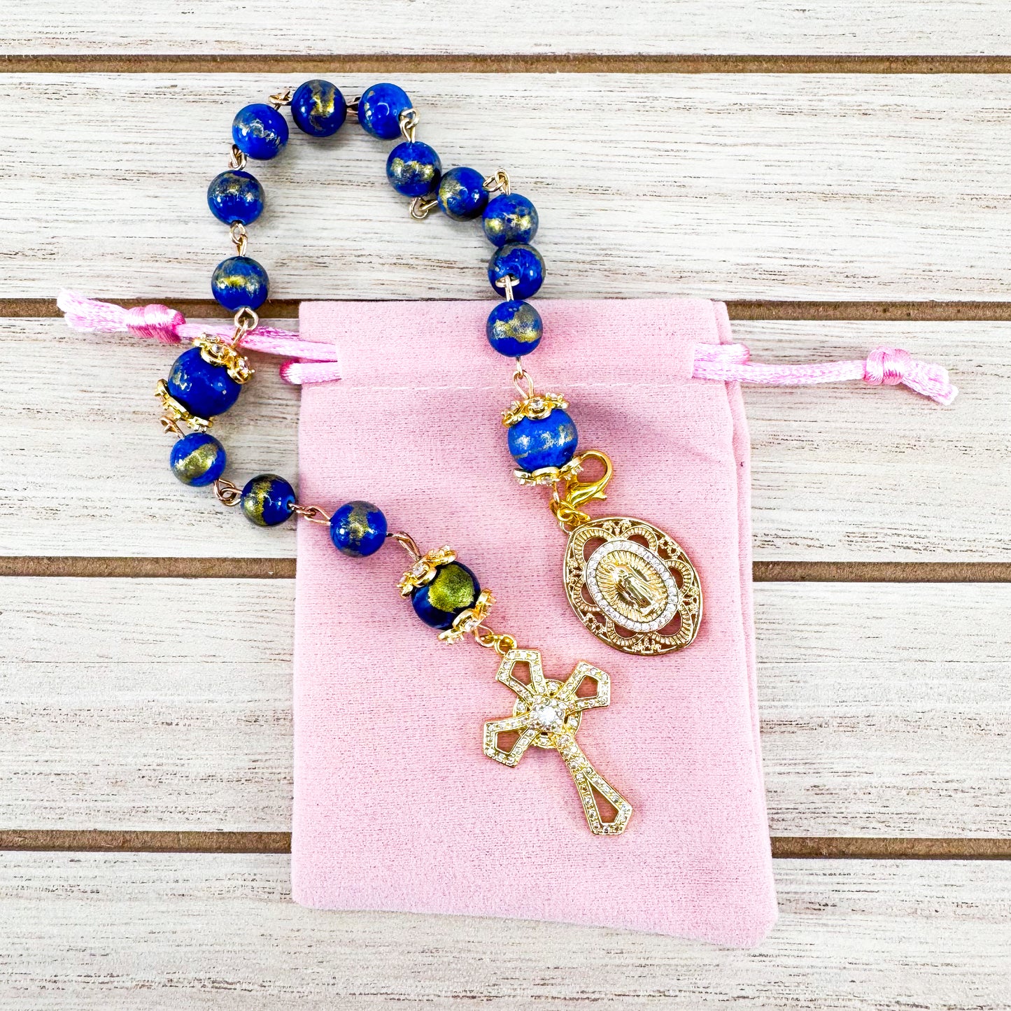 Luxury Catholic rosary bracelet handcrafted with natural Lapis Lazuli gemstone beads, a gold-tone cross with zirconia accents, and a Lady of Guadalupe medal. Adjustable beaded bracelet perfect for prayer, religious gifts, Confirmation, bridesmaid gifts, or everyday devotion. Made in Edmonton, AB, Canada.