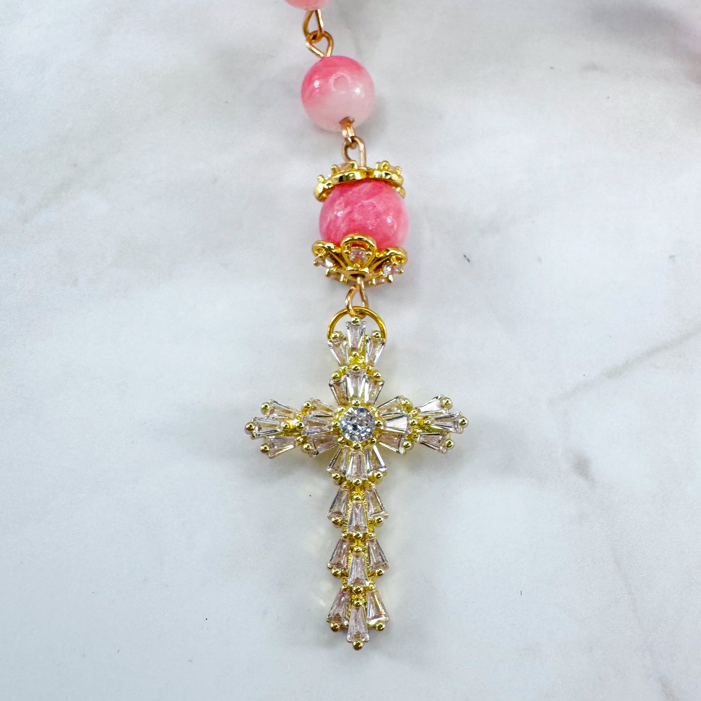 Luxury Catholic rosary bracelet handcrafted with natural pink persian jade gemstone beads, a gold-tone cross with zirconia accents, and a Lady of Guadalupe medal. Adjustable beaded bracelet perfect for prayer, religious gifts, Confirmation, bridesmaid gifts, or everyday devotion. Made in Edmonton, AB, Canada.