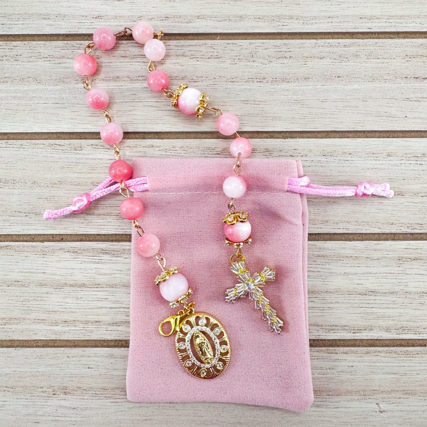 Luxury Catholic rosary bracelet handcrafted with natural pink persian jade gemstone beads, a gold-tone cross with zirconia accents, and a Lady of Guadalupe medal. Adjustable beaded bracelet perfect for prayer, religious gifts, Confirmation, bridesmaid gifts, or everyday devotion. Made in Edmonton, AB, Canada.