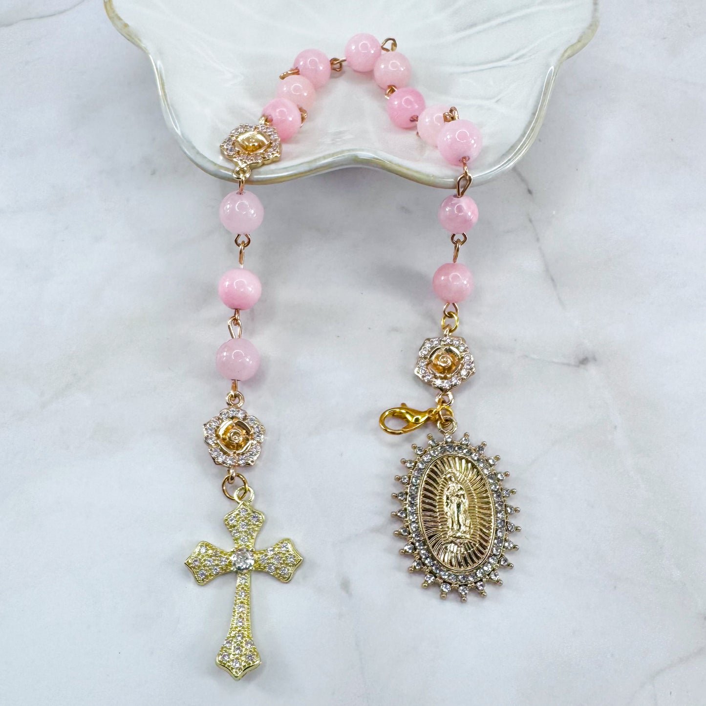 Luxury Catholic rosary bracelet handcrafted with natural rose quartz gemstone beads, a gold-tone cross with zirconia accents, and a Lady of Guadalupe medal. Adjustable beaded bracelet perfect for prayer, religious gifts, Confirmation, bridesmaid gifts, or everyday devotion. Made in Edmonton, AB, Canada.