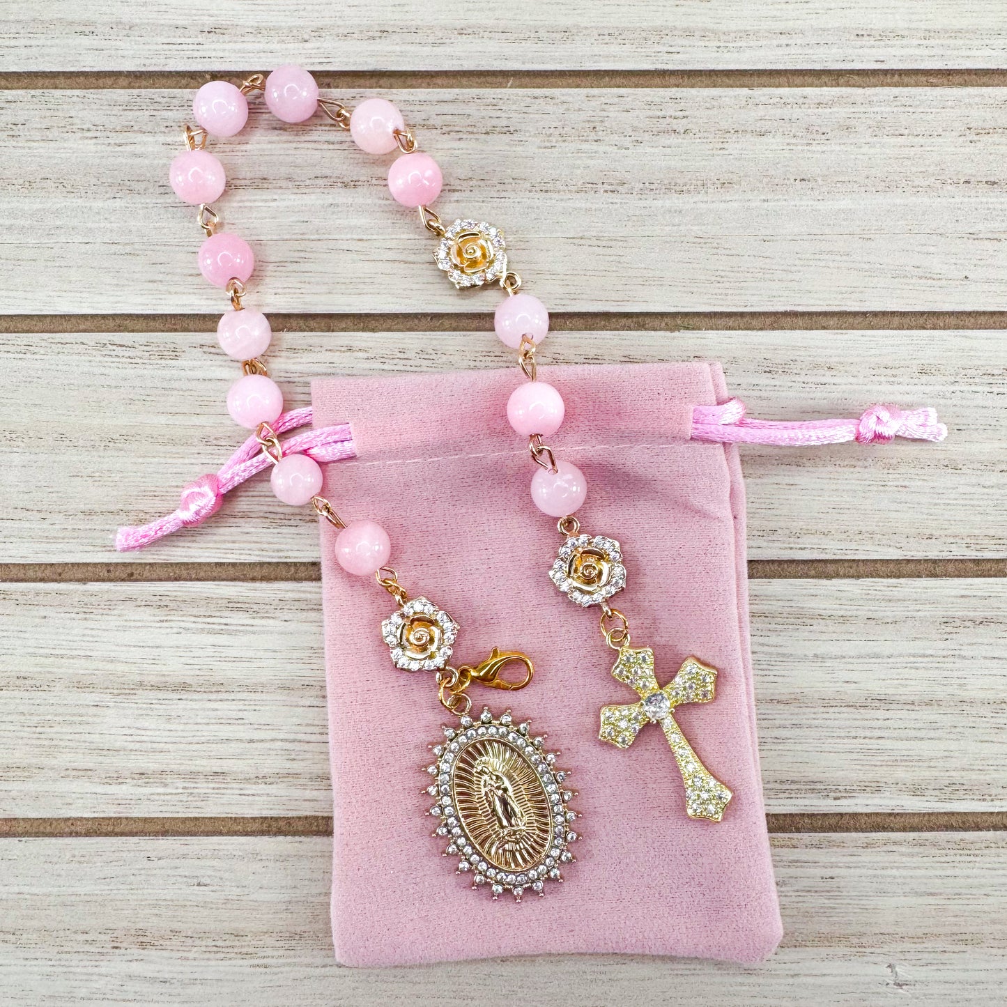 Luxury Catholic rosary bracelet handcrafted with natural rose quartz gemstone beads, a gold-tone cross with zirconia accents, and a Lady of Guadalupe medal. Adjustable beaded bracelet perfect for prayer, religious gifts, Confirmation, bridesmaid gifts, or everyday devotion. Made in Edmonton, AB, Canada.
