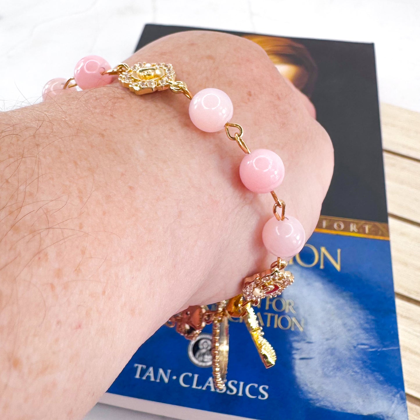 Luxury Catholic rosary bracelet handcrafted with natural rose quartz gemstone beads, a gold-tone cross with zirconia accents, and a Lady of Guadalupe medal. Adjustable beaded bracelet perfect for prayer, religious gifts, Confirmation, bridesmaid gifts, or everyday devotion. Made in Edmonton, AB, Canada.