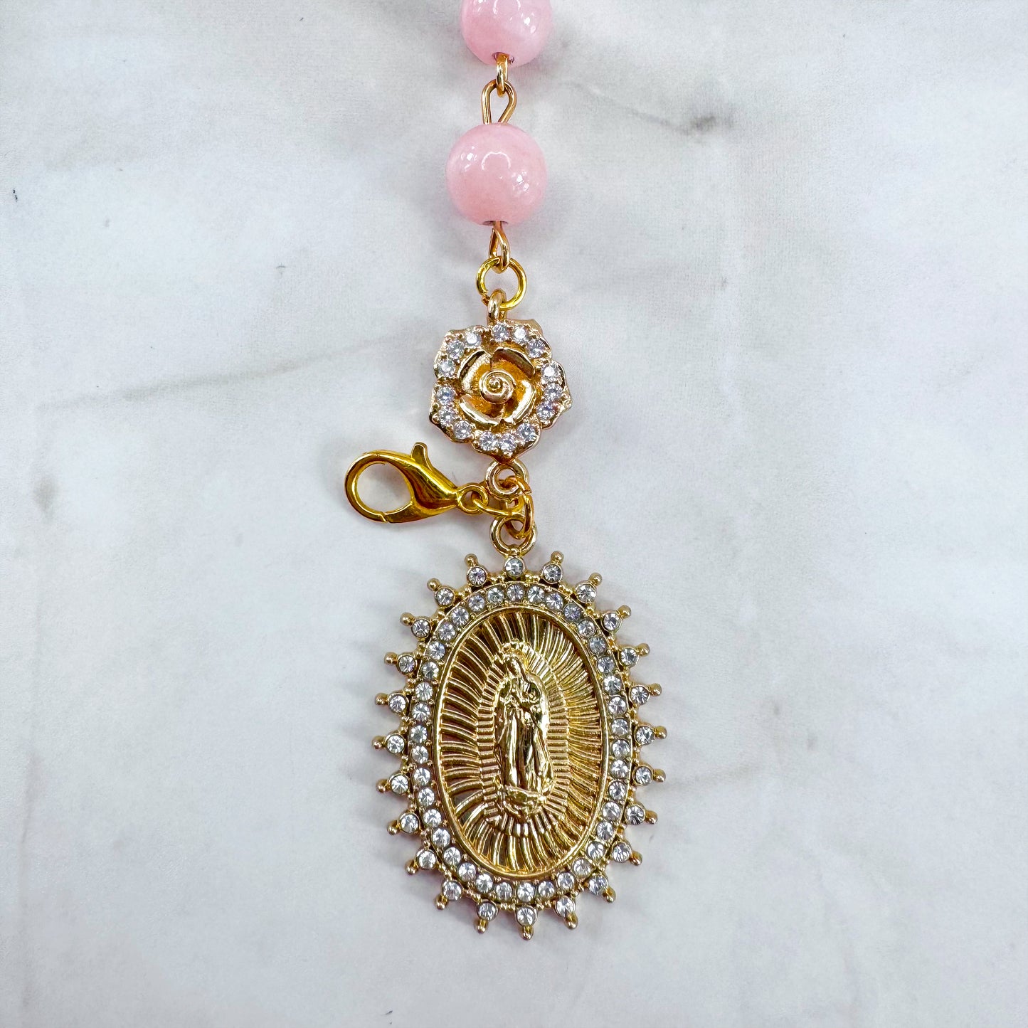 Luxury Catholic rosary bracelet handcrafted with natural rose quartz gemstone beads, a gold-tone cross with zirconia accents, and a Lady of Guadalupe medal. Adjustable beaded bracelet perfect for prayer, religious gifts, Confirmation, bridesmaid gifts, or everyday devotion. Made in Edmonton, AB, Canada.