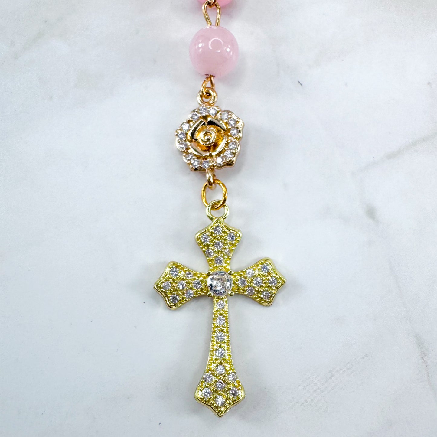 Luxury Catholic rosary bracelet handcrafted with natural rose quartz gemstone beads, a gold-tone cross with zirconia accents, and a Lady of Guadalupe medal. Adjustable beaded bracelet perfect for prayer, religious gifts, Confirmation, bridesmaid gifts, or everyday devotion. Made in Edmonton, AB, Canada.