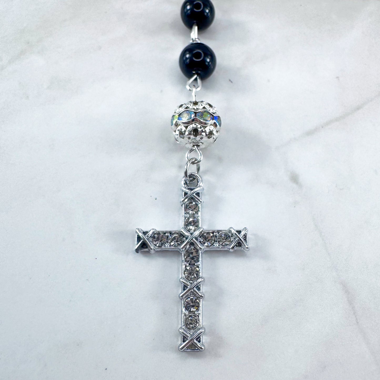 Luxury Catholic rosary bracelet handcrafted with natural black onyx gemstone beads, a silver-tone cross with zirconia accents, and a Lady of Guadalupe medal. Adjustable beaded bracelet perfect for prayer, religious gifts, Confirmation, bridesmaid gifts, or everyday devotion. Made in Edmonton, AB, Canada.