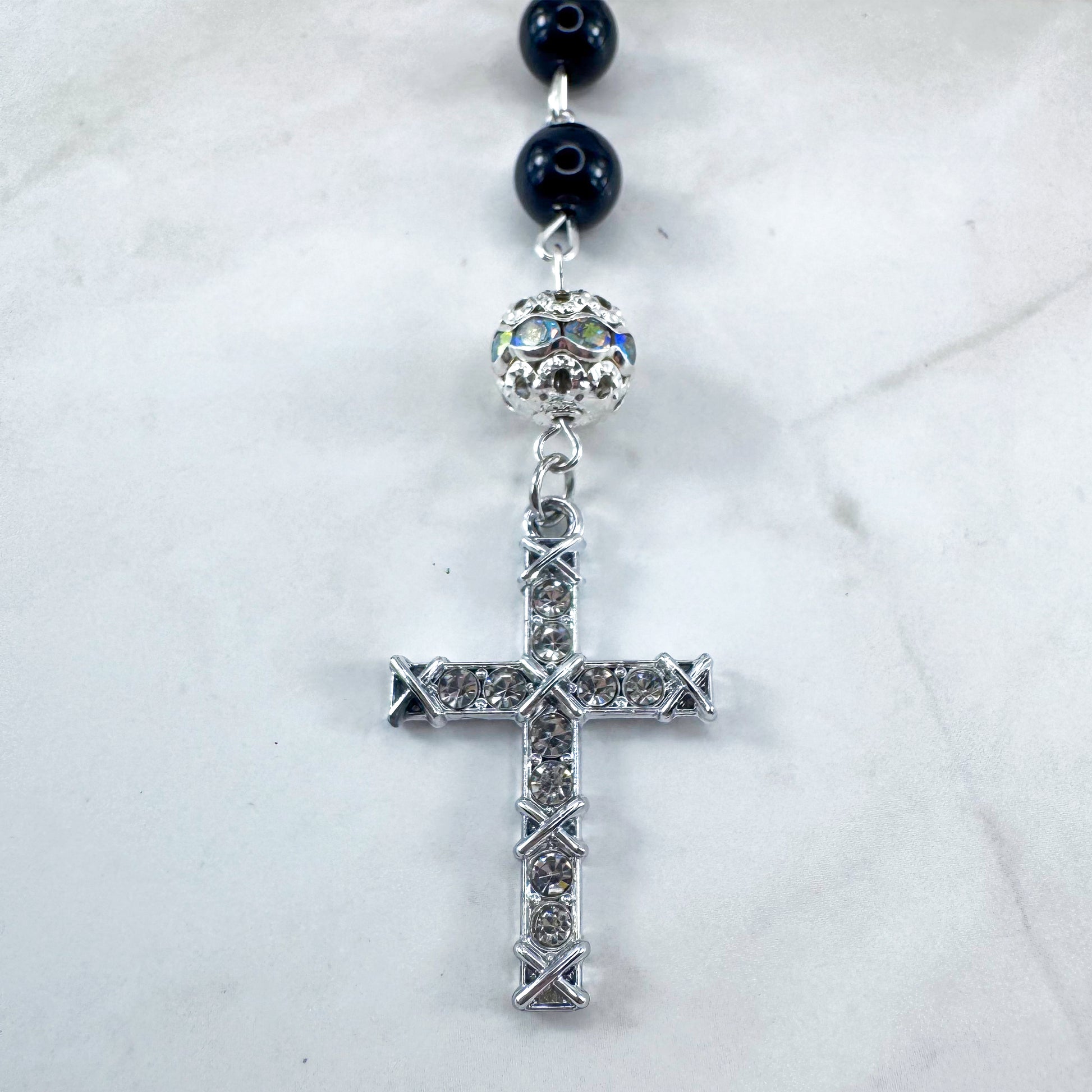 Luxury Catholic rosary bracelet handcrafted with natural black onyx gemstone beads, a silver-tone cross with zirconia accents, and a Lady of Guadalupe medal. Adjustable beaded bracelet perfect for prayer, religious gifts, Confirmation, bridesmaid gifts, or everyday devotion. Made in Edmonton, AB, Canada.