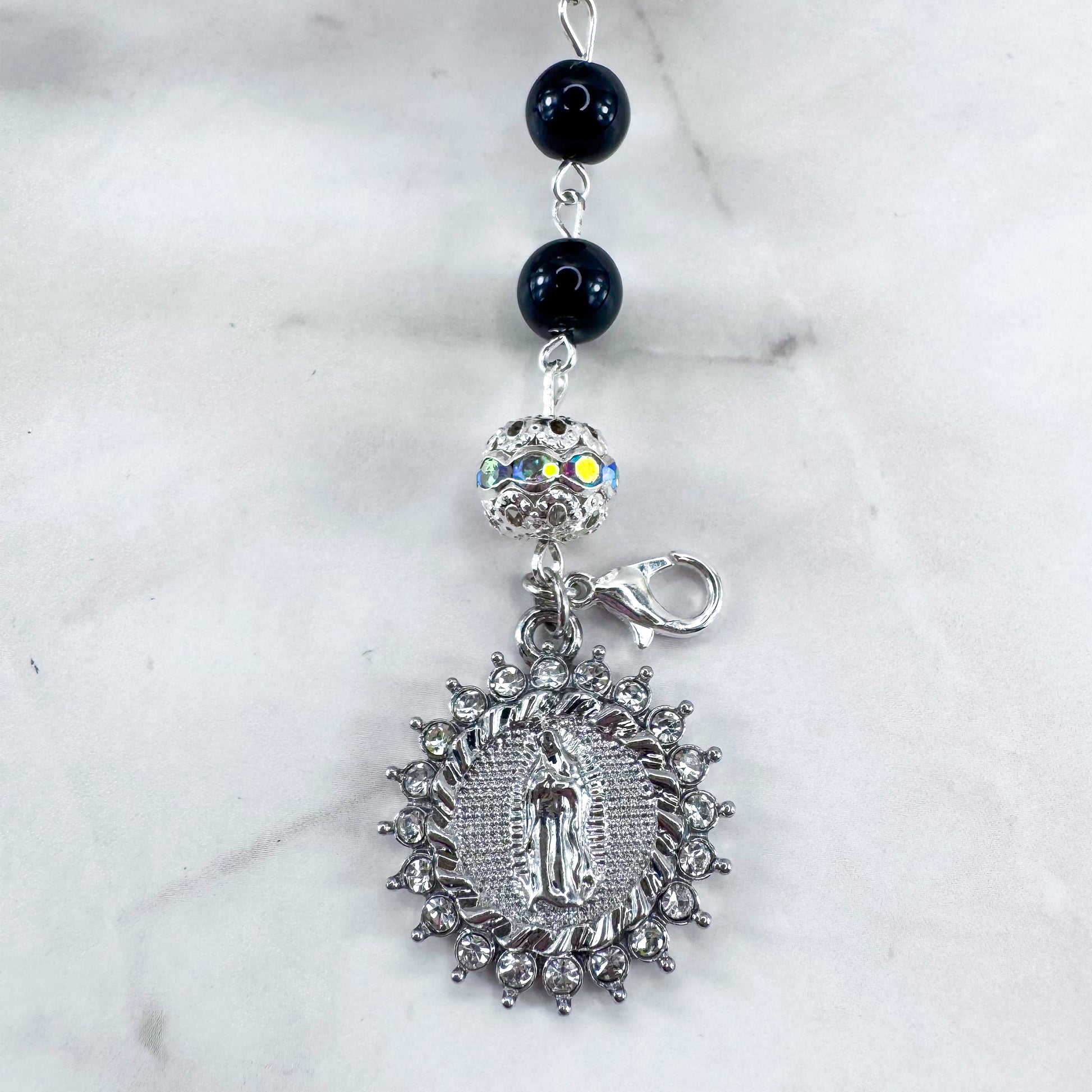 Luxury Catholic rosary bracelet handcrafted with natural black onyx gemstone beads, a silver-tone cross with zirconia accents, and a Lady of Guadalupe medal. Adjustable beaded bracelet perfect for prayer, religious gifts, Confirmation, bridesmaid gifts, or everyday devotion. Made in Edmonton, AB, Canada.