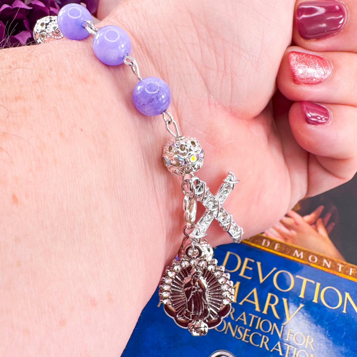 Luxury Catholic rosary bracelet handcrafted with natural Periwinkle Blue Angelite gemstone beads, a silver-tone cross with zirconia accents, and a Lady of Guadalupe medal. Adjustable beaded bracelet perfect for prayer, religious gifts, Confirmation, bridesmaid gifts, or everyday devotion. Made in Edmonton, AB, Canada.