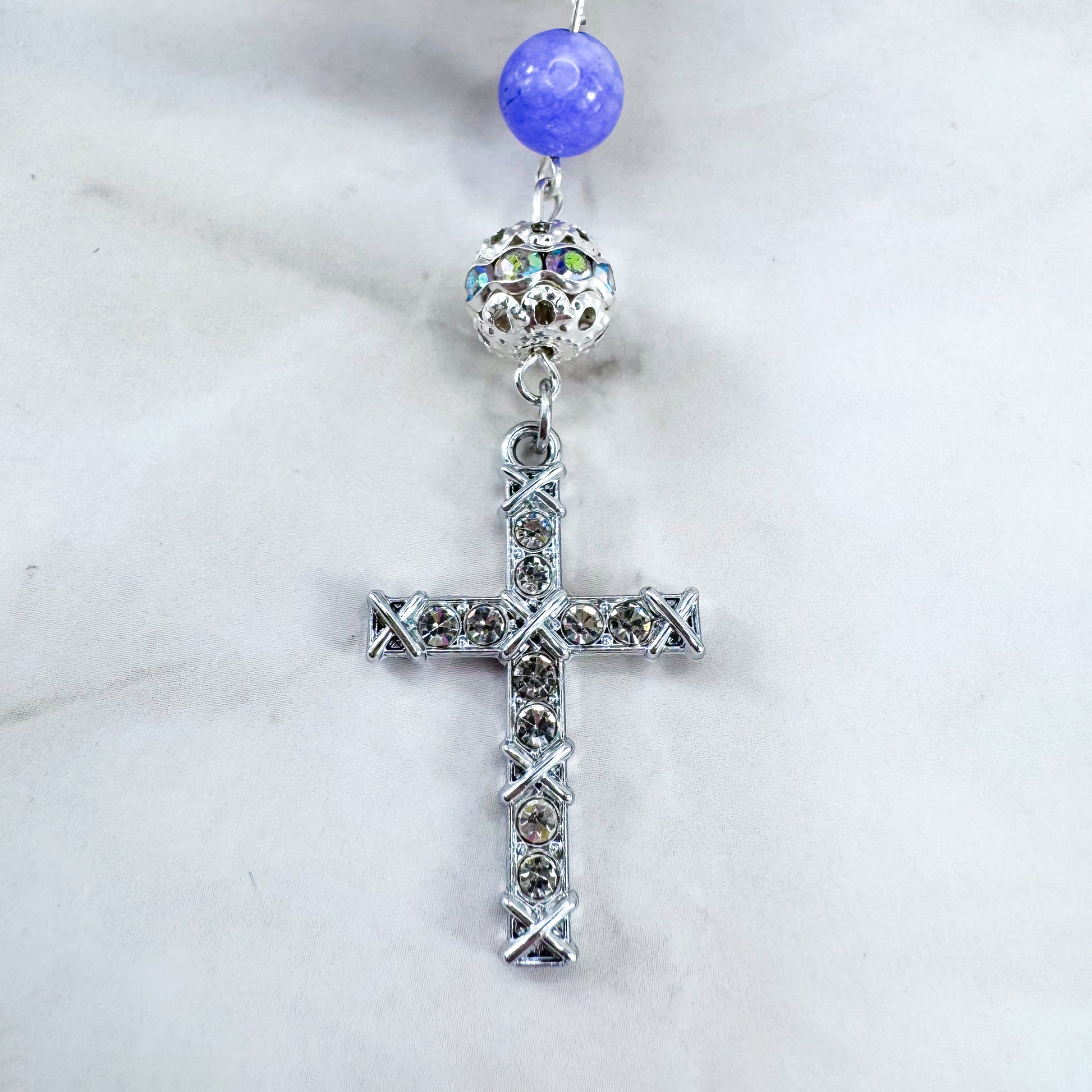 Luxury Catholic rosary bracelet handcrafted with natural Periwinkle Blue Angelite gemstone beads, a silver-tone cross with zirconia accents, and a Lady of Guadalupe medal. Adjustable beaded bracelet perfect for prayer, religious gifts, Confirmation, bridesmaid gifts, or everyday devotion. Made in Edmonton, AB, Canada.