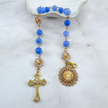 Luxury Catholic rosary bracelet handcrafted with natural blue quartz gemstone beads, a gold-tone cross with zirconia accents, and a Lady of Guadalupe medal. Adjustable beaded bracelet perfect for prayer, religious gifts, Confirmation, bridesmaid gifts, or everyday devotion. Made in Edmonton, AB, Canada