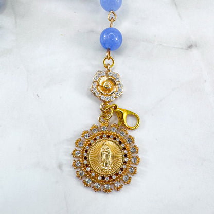 Luxury Catholic rosary bracelet handcrafted with natural blue quartz gemstone beads, a gold-tone cross with zirconia accents, and a Lady of Guadalupe medal. Adjustable beaded bracelet perfect for prayer, religious gifts, Confirmation, bridesmaid gifts, or everyday devotion. Made in Edmonton, AB, Canada.