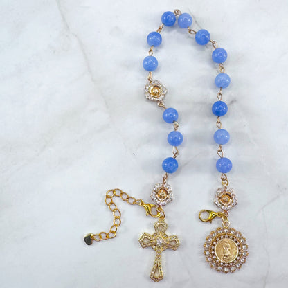 Luxury Catholic rosary bracelet handcrafted with natural blue quartz gemstone beads, a gold-tone cross with zirconia accents, and a Lady of Guadalupe medal. Adjustable beaded bracelet perfect for prayer, religious gifts, Confirmation, bridesmaid gifts, or everyday devotion. Made in Edmonton, AB, Canada.