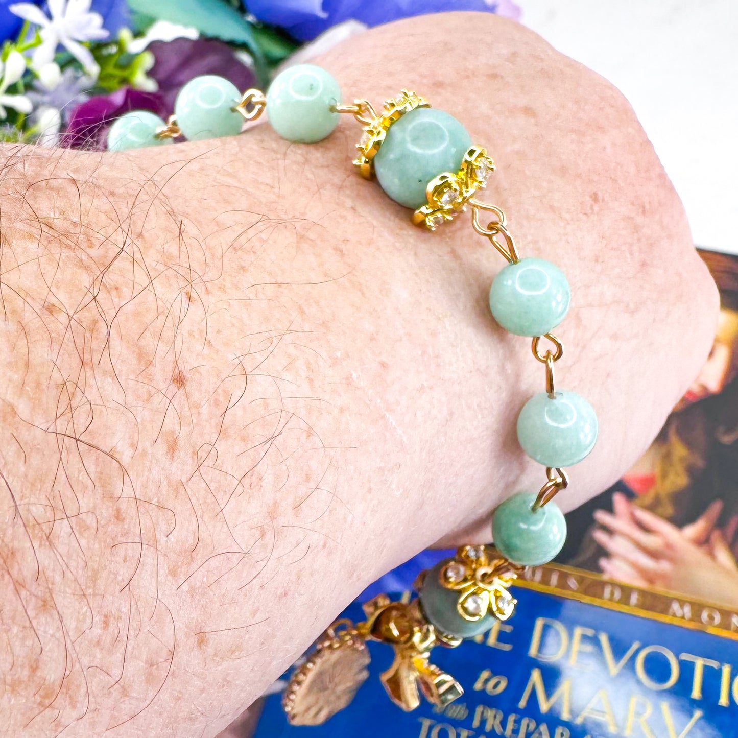 Luxury Catholic rosary bracelet handcrafted with natural Emerald Green Jade gemstone beads, a gold-tone cross with zirconia accents, and a Lady of Guadalupe medal. Adjustable beaded bracelet perfect for prayer, religious gifts, Confirmation, bridesmaid gifts, or everyday devotion. Made in Edmonton, AB, Canada.