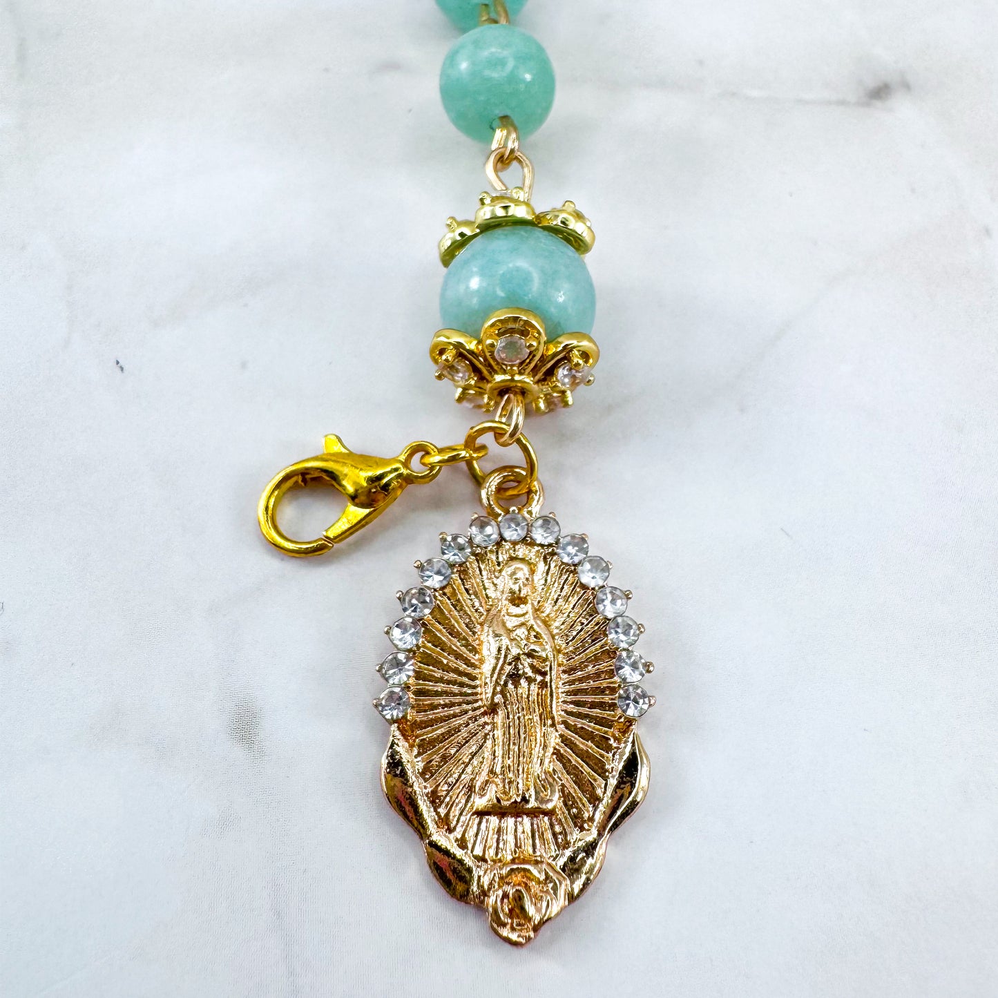 Luxury Catholic rosary bracelet handcrafted with natural Emerald Green Jade gemstone beads, a gold-tone cross with zirconia accents, and a Lady of Guadalupe medal. Adjustable beaded bracelet perfect for prayer, religious gifts, Confirmation, bridesmaid gifts, or everyday devotion. Made in Edmonton, AB, Canada.