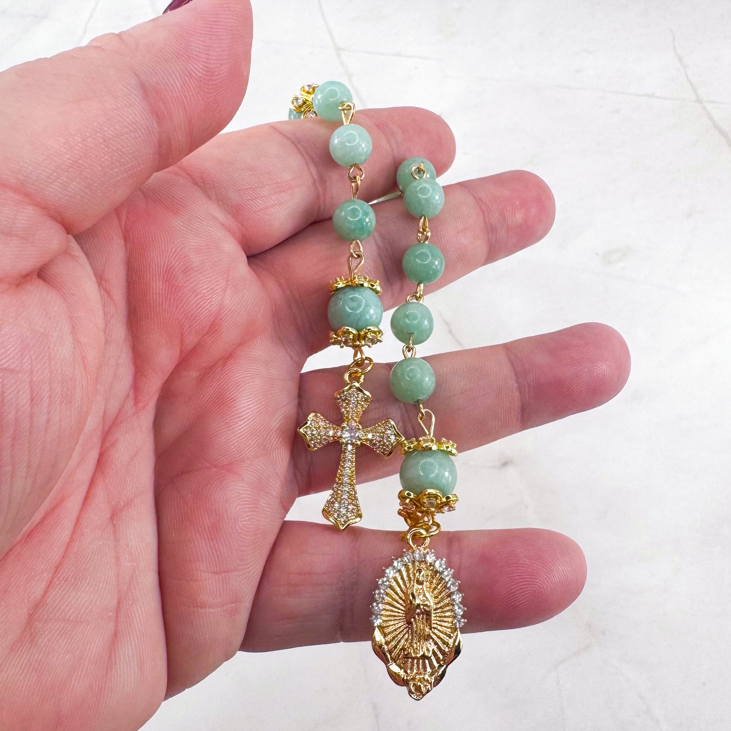 Luxury Catholic rosary bracelet handcrafted with natural Emerald Green Jade gemstone beads, a gold-tone cross with zirconia accents, and a Lady of Guadalupe medal. Adjustable beaded bracelet perfect for prayer, religious gifts, Confirmation, bridesmaid gifts, or everyday devotion. Made in Edmonton, AB, Canada.