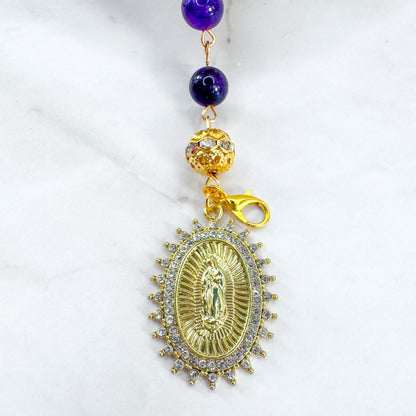 Handmade Catholic rosary bracelet with amethyst beads, sparkling gold cross, and Our Lady of Guadalupe medal. Perfect for gifts or prayer. Made in Edmonton, AB, Canada.