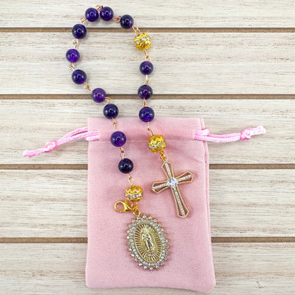 Handmade Catholic rosary bracelet with amethyst beads, sparkling gold cross, and Our Lady of Guadalupe medal. Perfect for gifts or prayer. Made in Edmonton, AB, Canada.
