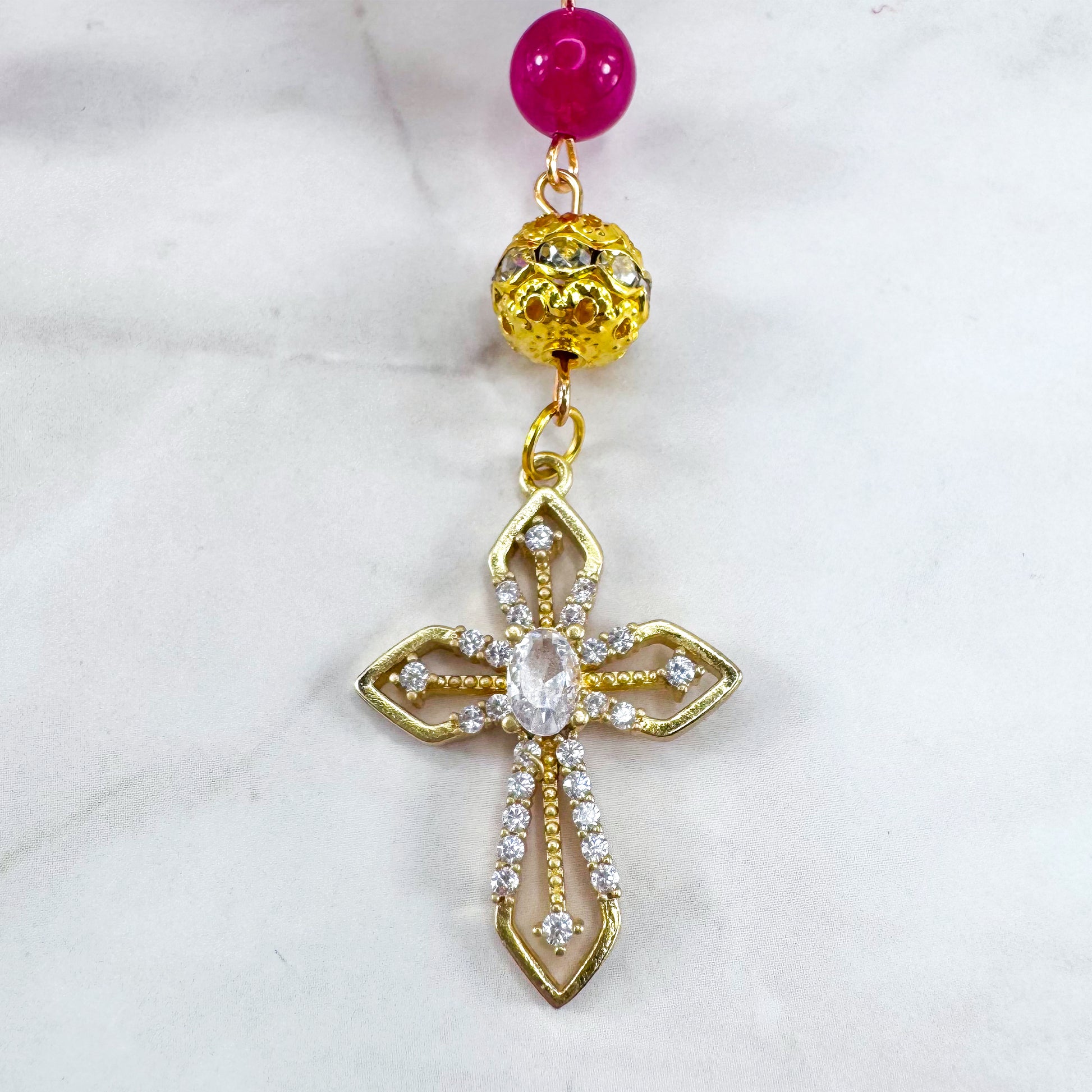 Luxury Catholic rosary bracelet handcrafted with natural Rose Red Chalcedony gemstone beads, a gold-tone cross with zirconia accents, and a Lady of Guadalupe medal. Adjustable beaded bracelet perfect for prayer, religious gifts, Confirmation, bridesmaid gifts, or everyday devotion. Made in Edmonton, AB, Canada.