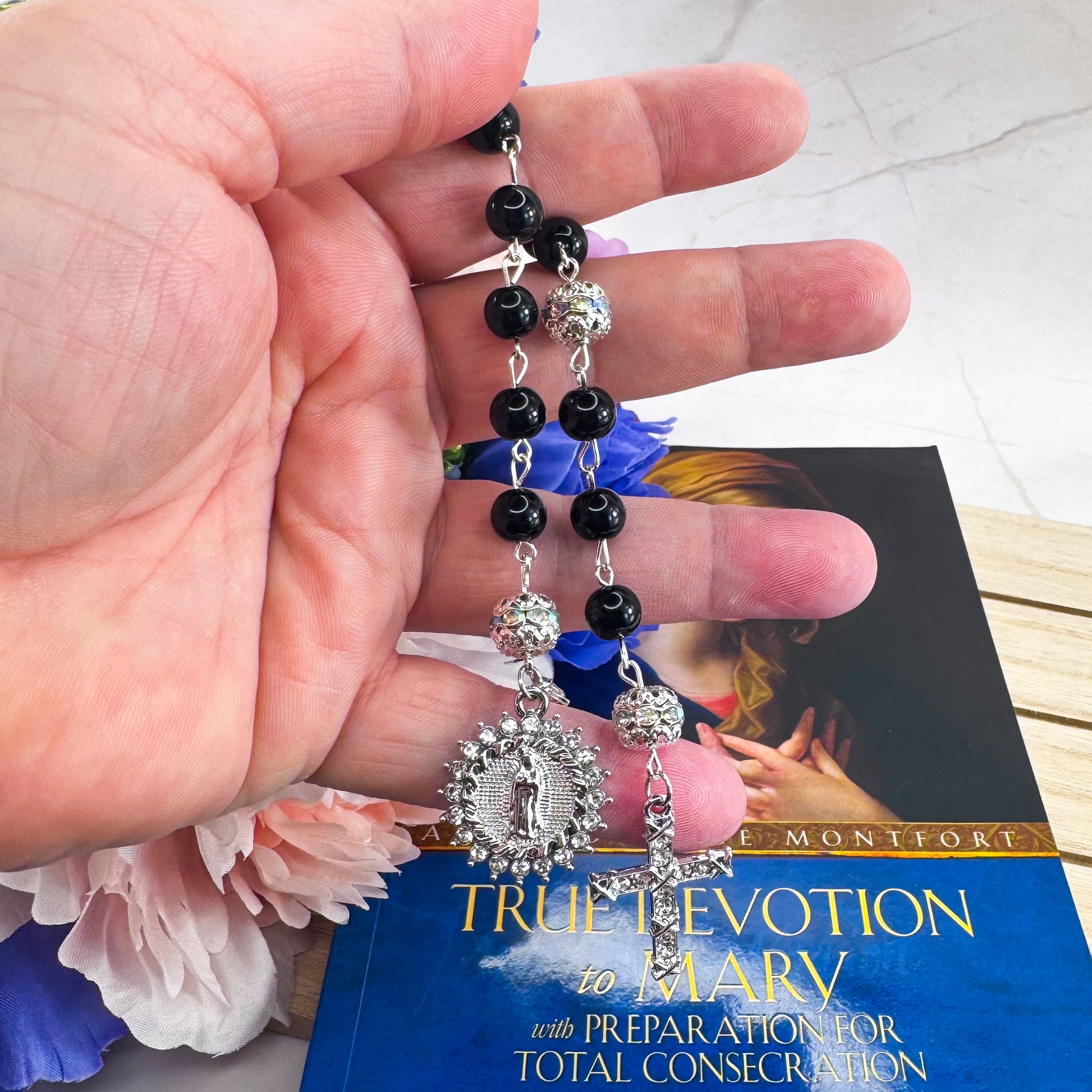 Luxury Catholic rosary bracelet handcrafted with natural black onyx gemstone beads, a silver-tone cross with zirconia accents, and a Lady of Guadalupe medal. Adjustable beaded bracelet perfect for prayer, religious gifts, Confirmation, bridesmaid gifts, or everyday devotion. Made in Edmonton, AB, Canada.