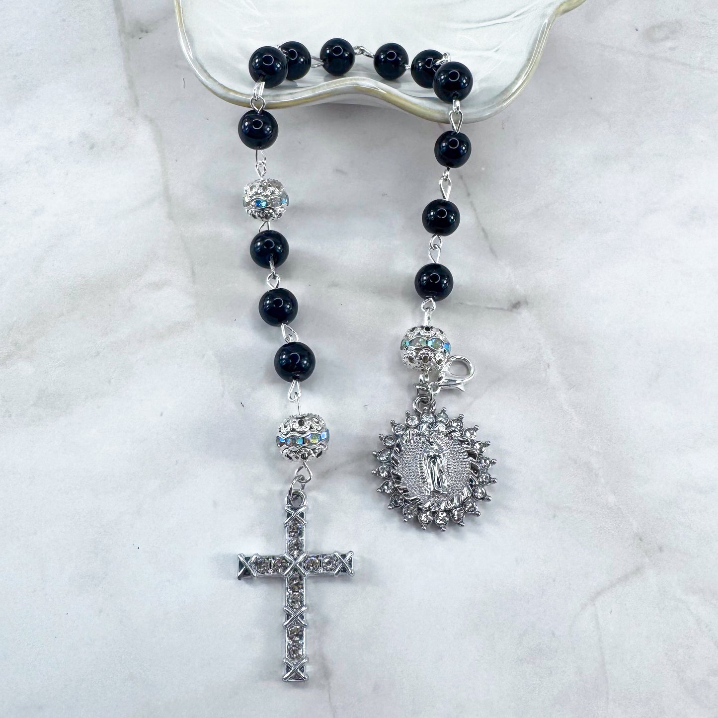 Luxury Catholic rosary bracelet handcrafted with natural black onyx gemstone beads, a silver-tone cross with zirconia accents, and a Lady of Guadalupe medal. Adjustable beaded bracelet perfect for prayer, religious gifts, Confirmation, bridesmaid gifts, or everyday devotion. Made in Edmonton, AB, Canada.