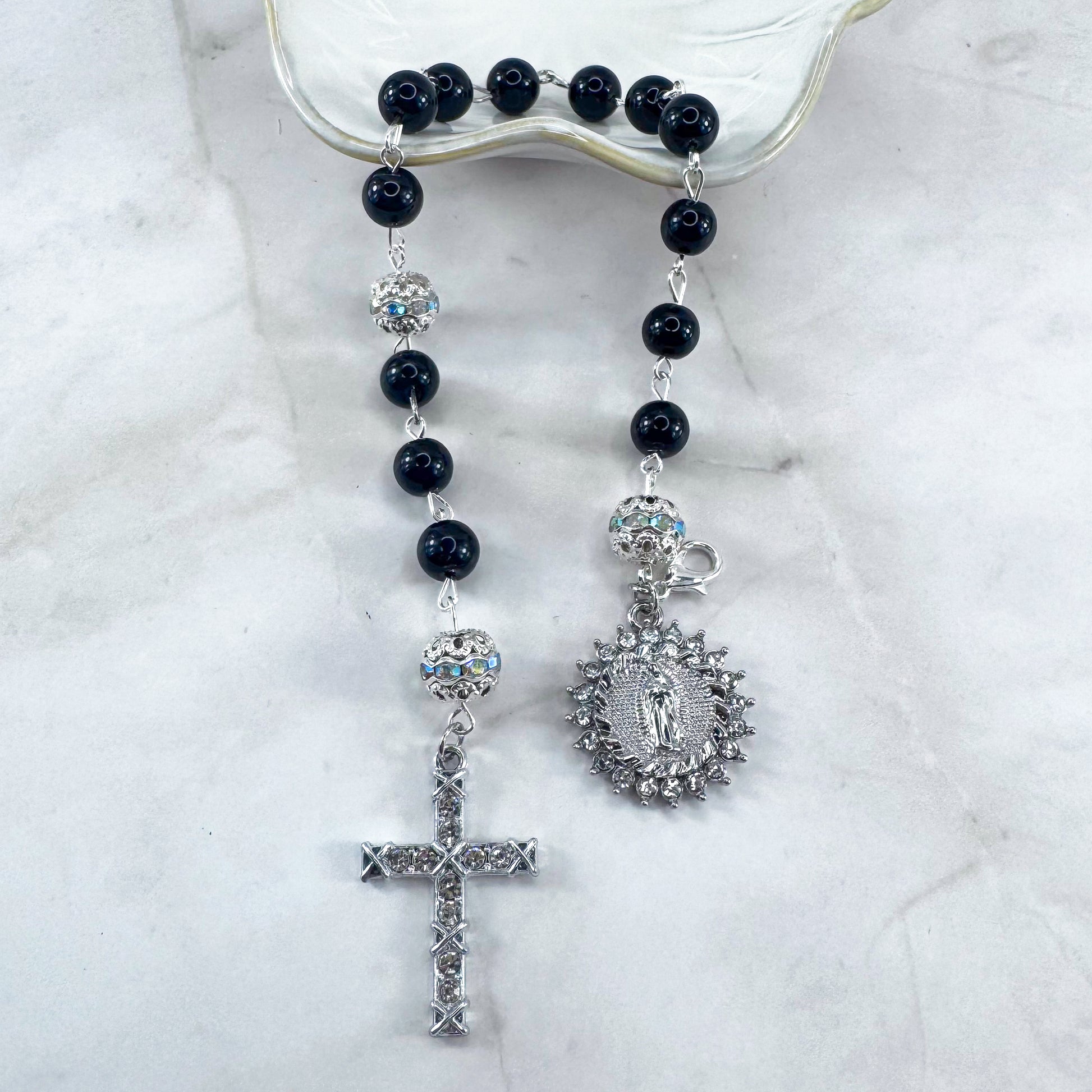 Luxury Catholic rosary bracelet handcrafted with natural black onyx gemstone beads, a silver-tone cross with zirconia accents, and a Lady of Guadalupe medal. Adjustable beaded bracelet perfect for prayer, religious gifts, Confirmation, bridesmaid gifts, or everyday devotion. Made in Edmonton, AB, Canada.