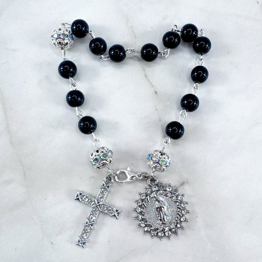 Luxury Catholic rosary bracelet handcrafted with natural black onyx gemstone beads, a silver-tone cross with zirconia accents, and a Lady of Guadalupe medal. Adjustable beaded bracelet perfect for prayer, religious gifts, Confirmation, bridesmaid gifts, or everyday devotion. Made in Edmonton, AB, Canada.