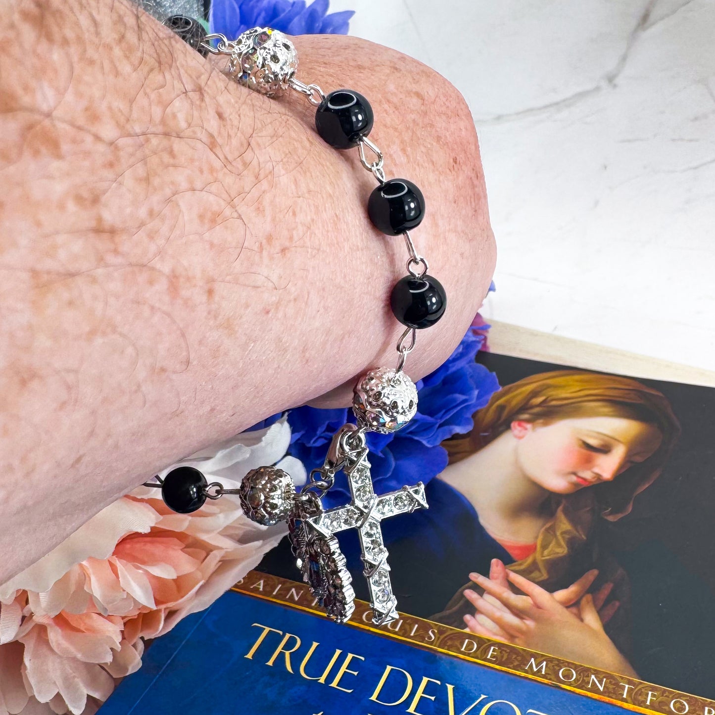 Luxury Catholic rosary bracelet handcrafted with natural black onyx gemstone beads, a silver-tone cross with zirconia accents, and a Lady of Guadalupe medal. Adjustable beaded bracelet perfect for prayer, religious gifts, Confirmation, bridesmaid gifts, or everyday devotion. Made in Edmonton, AB, Canada.