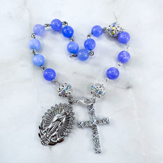 Luxury Catholic rosary bracelet handcrafted with natural Periwinkle Blue Angelite gemstone beads, a silver-tone cross with zirconia accents, and a Lady of Guadalupe medal. Adjustable beaded bracelet perfect for prayer, religious gifts, Confirmation, bridesmaid gifts, or everyday devotion. Made in Edmonton, AB, Canada.