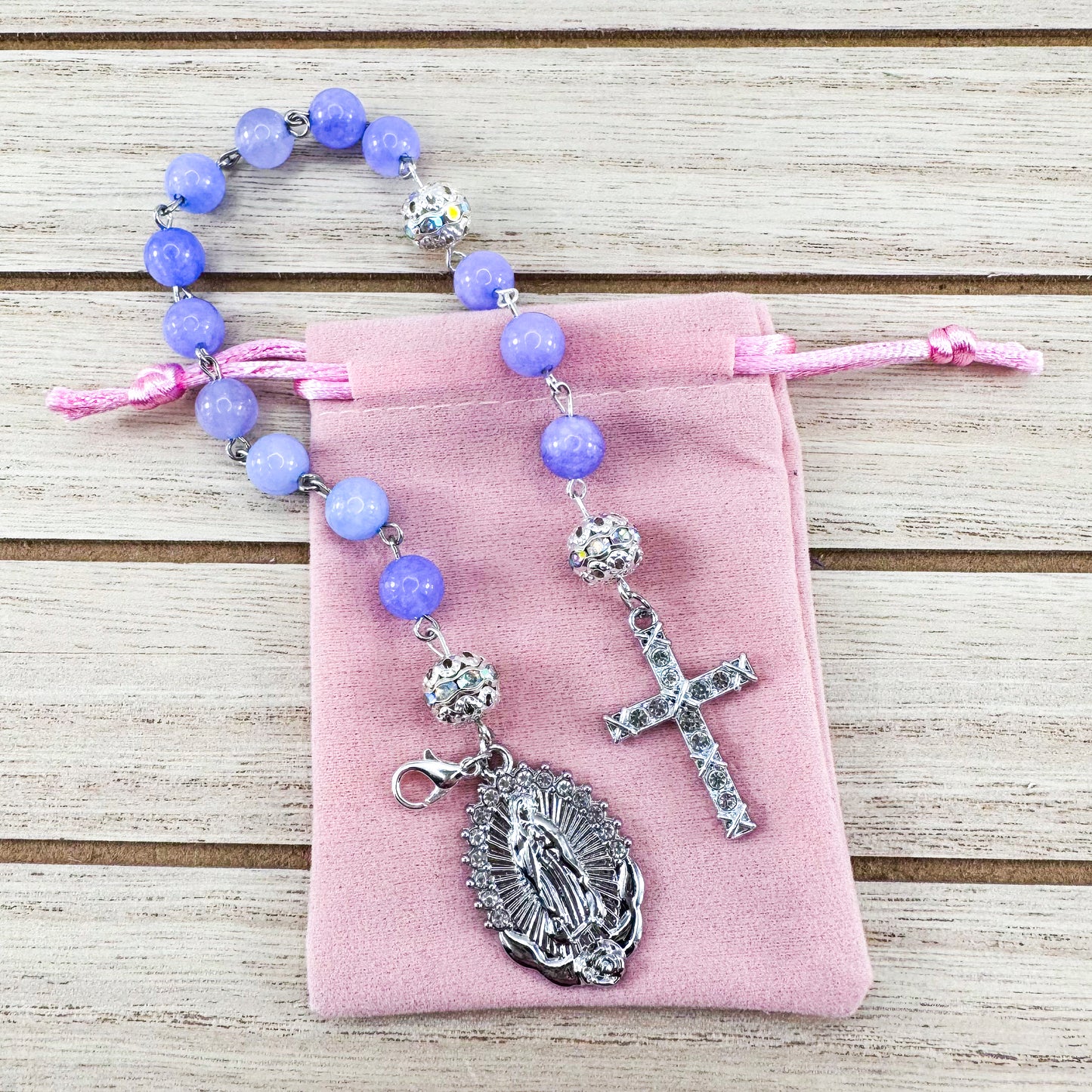 Luxury Catholic rosary bracelet handcrafted with natural Periwinkle Blue Angelite gemstone beads, a silver-tone cross with zirconia accents, and a Lady of Guadalupe medal. Adjustable beaded bracelet perfect for prayer, religious gifts, Confirmation, bridesmaid gifts, or everyday devotion. Made in Edmonton, AB, Canada.