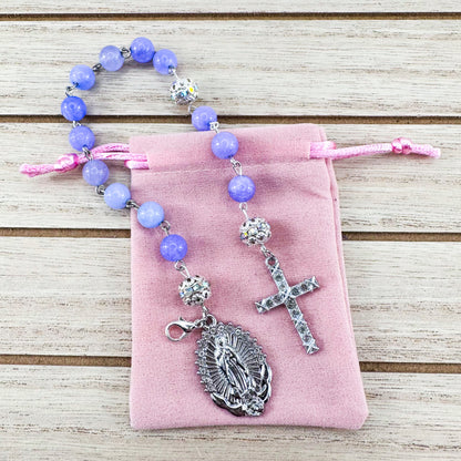 Luxury Catholic rosary bracelet handcrafted with natural Periwinkle Blue Angelite gemstone beads, a silver-tone cross with zirconia accents, and a Lady of Guadalupe medal. Adjustable beaded bracelet perfect for prayer, religious gifts, Confirmation, bridesmaid gifts, or everyday devotion. Made in Edmonton, AB, Canada.