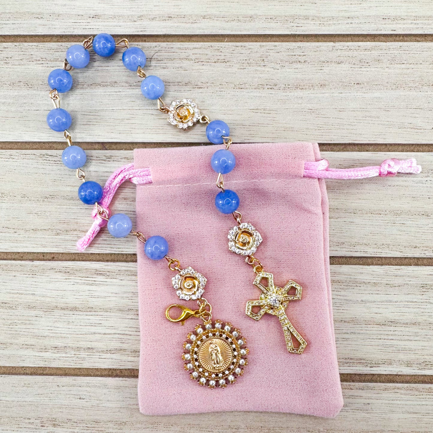 Luxury Catholic rosary bracelet handcrafted with natural blue quartz gemstone beads, a gold-tone cross with zirconia accents, and a Lady of Guadalupe medal. Adjustable beaded bracelet perfect for prayer, religious gifts, Confirmation, bridesmaid gifts, or everyday devotion. Made in Edmonton, AB, Canada.