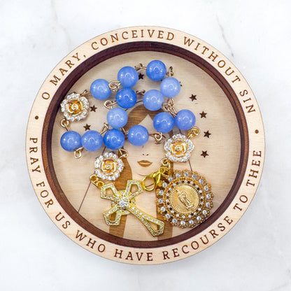 Luxury Catholic rosary bracelet handcrafted with natural blue quartz gemstone beads, a gold-tone cross with zirconia accents, and a Lady of Guadalupe medal. Adjustable beaded bracelet perfect for prayer, religious gifts, Confirmation, bridesmaid gifts, or everyday devotion. Made in Edmonton, AB, Canada.