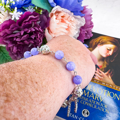 Luxury Catholic rosary bracelet handcrafted with natural Periwinkle Blue Angelite gemstone beads, a silver-tone cross with zirconia accents, and a Lady of Guadalupe medal. Adjustable beaded bracelet perfect for prayer, religious gifts, Confirmation, bridesmaid gifts, or everyday devotion. Made in Edmonton, AB, Canada.