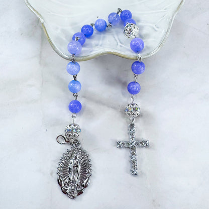 Luxury Catholic rosary bracelet handcrafted with natural Periwinkle Blue Angelite gemstone beads, a silver-tone cross with zirconia accents, and a Lady of Guadalupe medal. Adjustable beaded bracelet perfect for prayer, religious gifts, Confirmation, bridesmaid gifts, or everyday devotion. Made in Edmonton, AB, Canada.