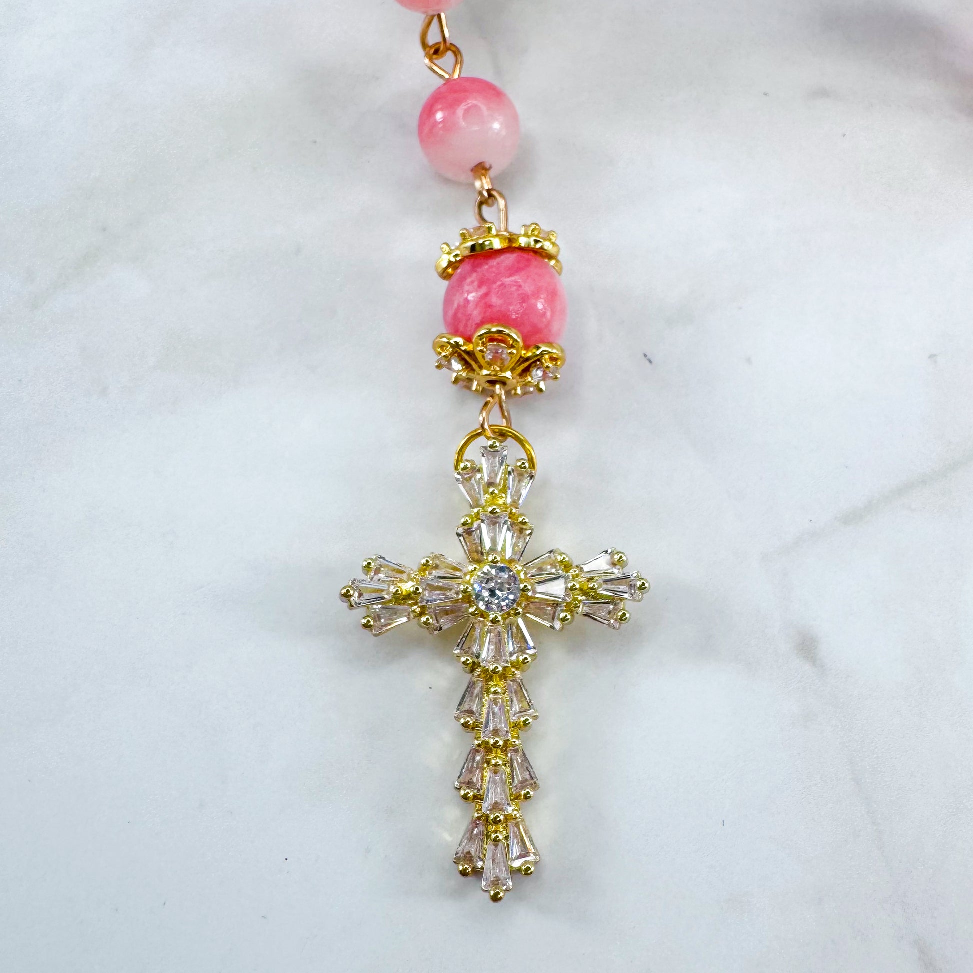 Luxury Catholic rosary bracelet handcrafted with natural pink persian jade gemstone beads, a gold-tone cross with zirconia accents, and a Lady of Guadalupe medal. Adjustable beaded bracelet perfect for prayer, religious gifts, Confirmation, bridesmaid gifts, or everyday devotion. Made in Edmonton, AB, Canada.