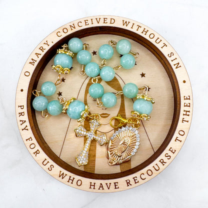Luxury Catholic rosary bracelet handcrafted with natural Emerald Green Jade gemstone beads, a gold-tone cross with zirconia accents, and a Lady of Guadalupe medal. Adjustable beaded bracelet perfect for prayer, religious gifts, Confirmation, bridesmaid gifts, or everyday devotion. Made in Edmonton, AB, Canada.