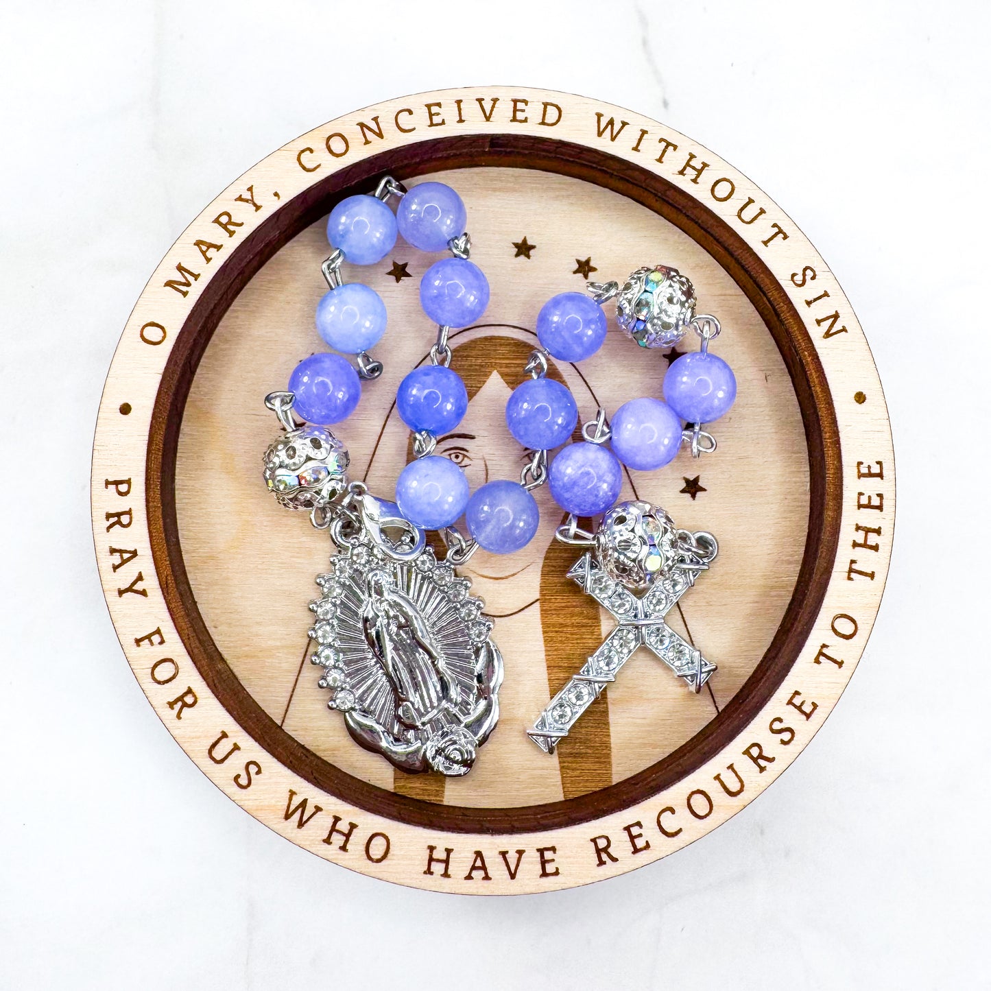 Luxury Catholic rosary bracelet handcrafted with natural Periwinkle Blue Angelite gemstone beads, a silver-tone cross with zirconia accents, and a Lady of Guadalupe medal. Adjustable beaded bracelet perfect for prayer, religious gifts, Confirmation, bridesmaid gifts, or everyday devotion. Made in Edmonton, AB, Canada.