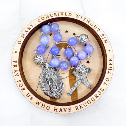 Luxury Catholic rosary bracelet handcrafted with natural Periwinkle Blue Angelite gemstone beads, a silver-tone cross with zirconia accents, and a Lady of Guadalupe medal. Adjustable beaded bracelet perfect for prayer, religious gifts, Confirmation, bridesmaid gifts, or everyday devotion. Made in Edmonton, AB, Canada.