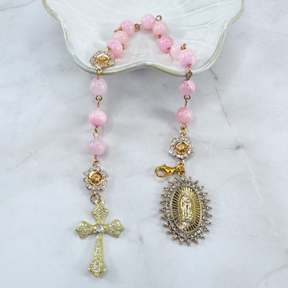 Luxury Catholic rosary bracelet handcrafted with natural rose quartz gemstone beads, a gold-tone cross with zirconia accents, and a Lady of Guadalupe medal. Adjustable beaded bracelet perfect for prayer, religious gifts, Confirmation, bridesmaid gifts, or everyday devotion. Made in Edmonton, AB, Canada.