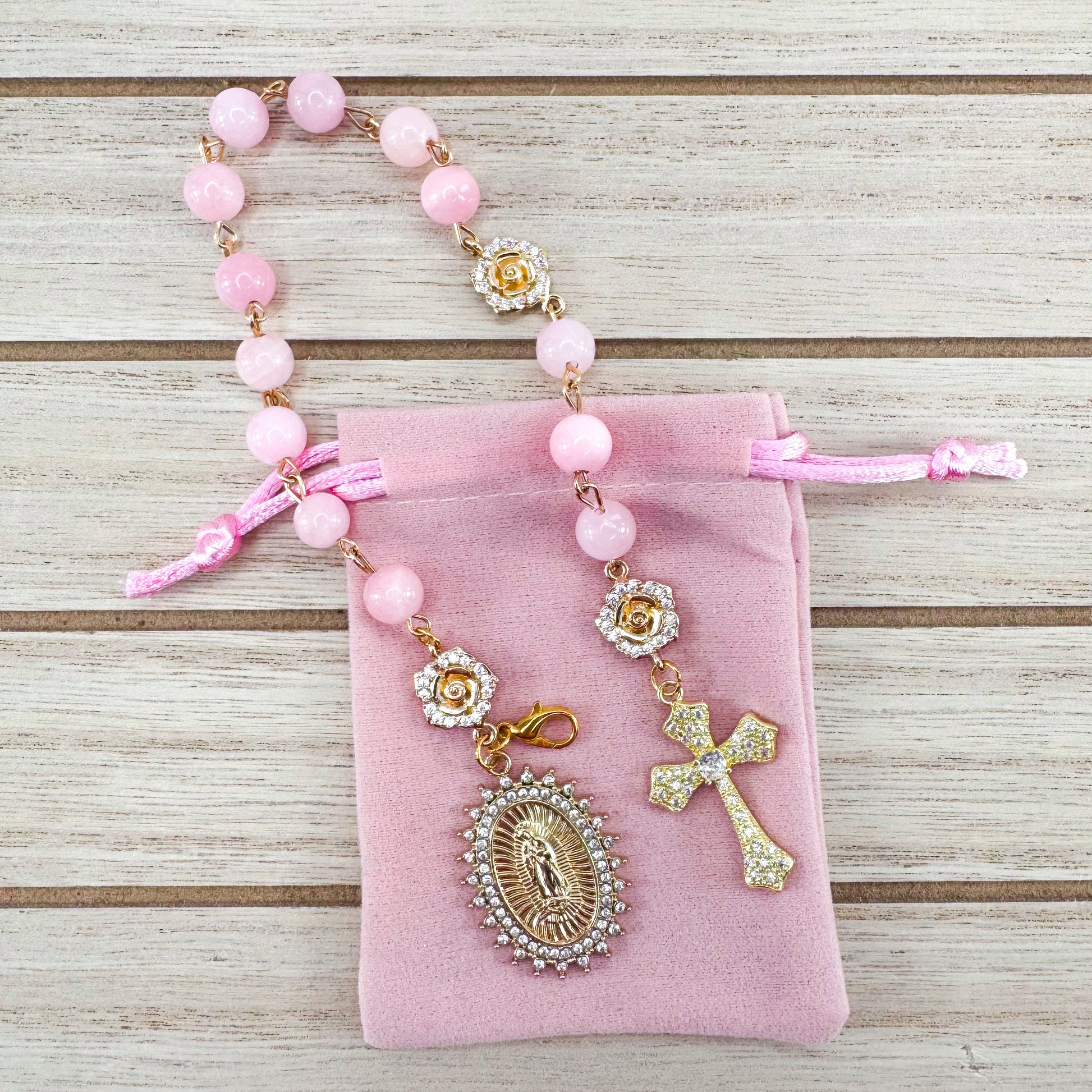 Luxury Catholic rosary bracelet handcrafted with natural rose quartz gemstone beads, a gold-tone cross with zirconia accents, and a Lady of Guadalupe medal. Adjustable beaded bracelet perfect for prayer, religious gifts, Confirmation, bridesmaid gifts, or everyday devotion. Made in Edmonton, AB, Canada.