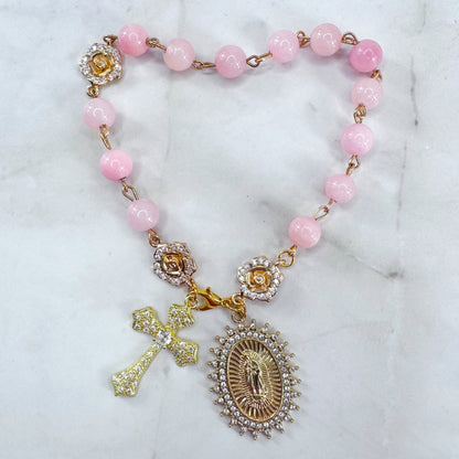 Luxury Catholic rosary bracelet handcrafted with natural rose quartz gemstone beads, a gold-tone cross with zirconia accents, and a Lady of Guadalupe medal. Adjustable beaded bracelet perfect for prayer, religious gifts, Confirmation, bridesmaid gifts, or everyday devotion. Made in Edmonton, AB, Canada.