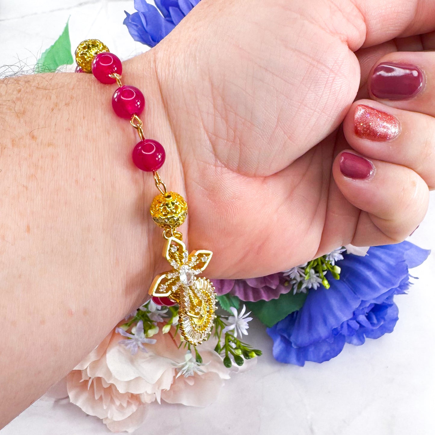 Luxury Catholic rosary bracelet handcrafted with natural Rose Red Chalcedony gemstone beads, a gold-tone cross with zirconia accents, and a Lady of Guadalupe medal. Adjustable beaded bracelet perfect for prayer, religious gifts, Confirmation, bridesmaid gifts, or everyday devotion. Made in Edmonton, AB, Canada.