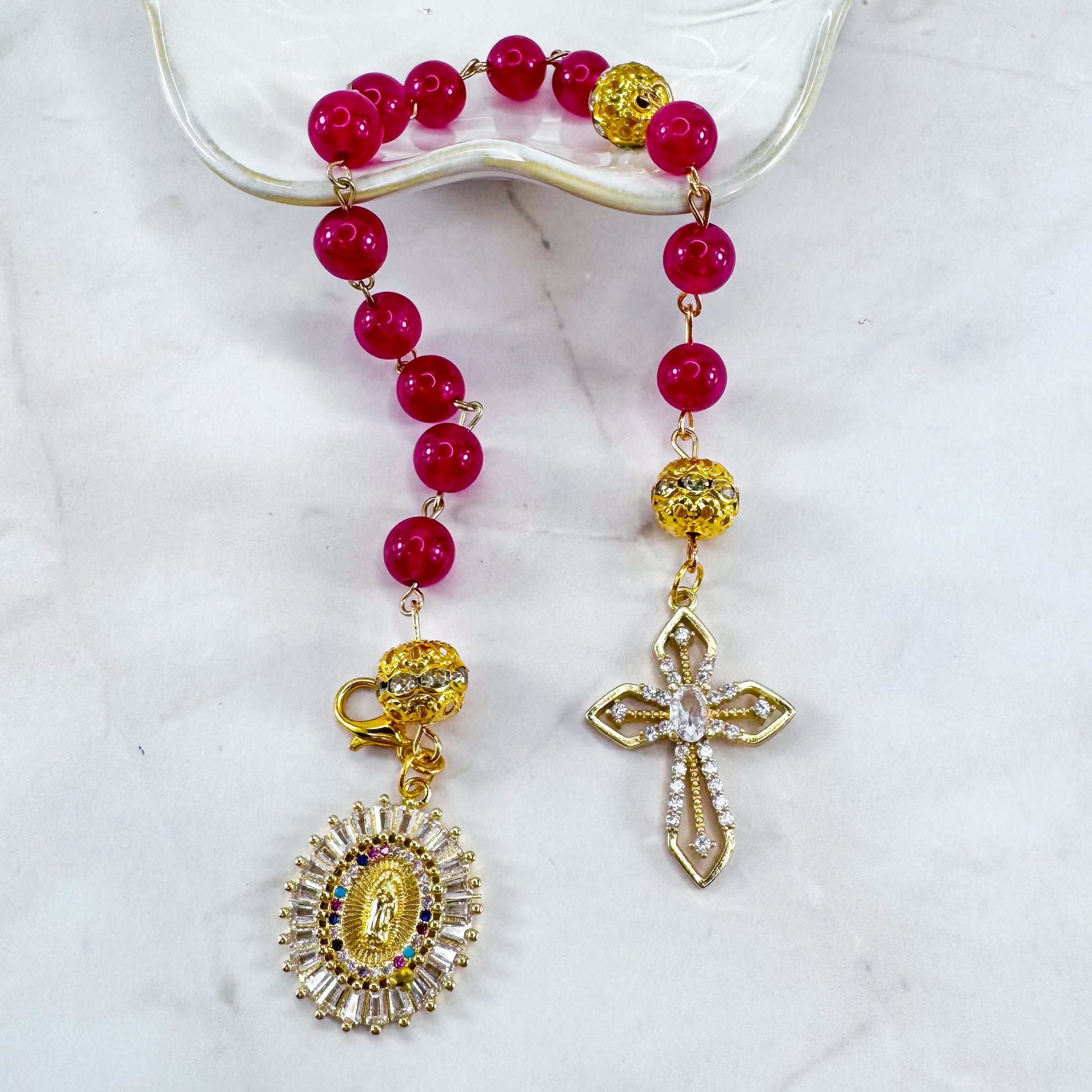 Luxury Catholic rosary bracelet handcrafted with natural Rose Red Chalcedony gemstone beads, a gold-tone cross with zirconia accents, and a Lady of Guadalupe medal. Adjustable beaded bracelet perfect for prayer, religious gifts, Confirmation, bridesmaid gifts, or everyday devotion. Made in Edmonton, AB, Canada.