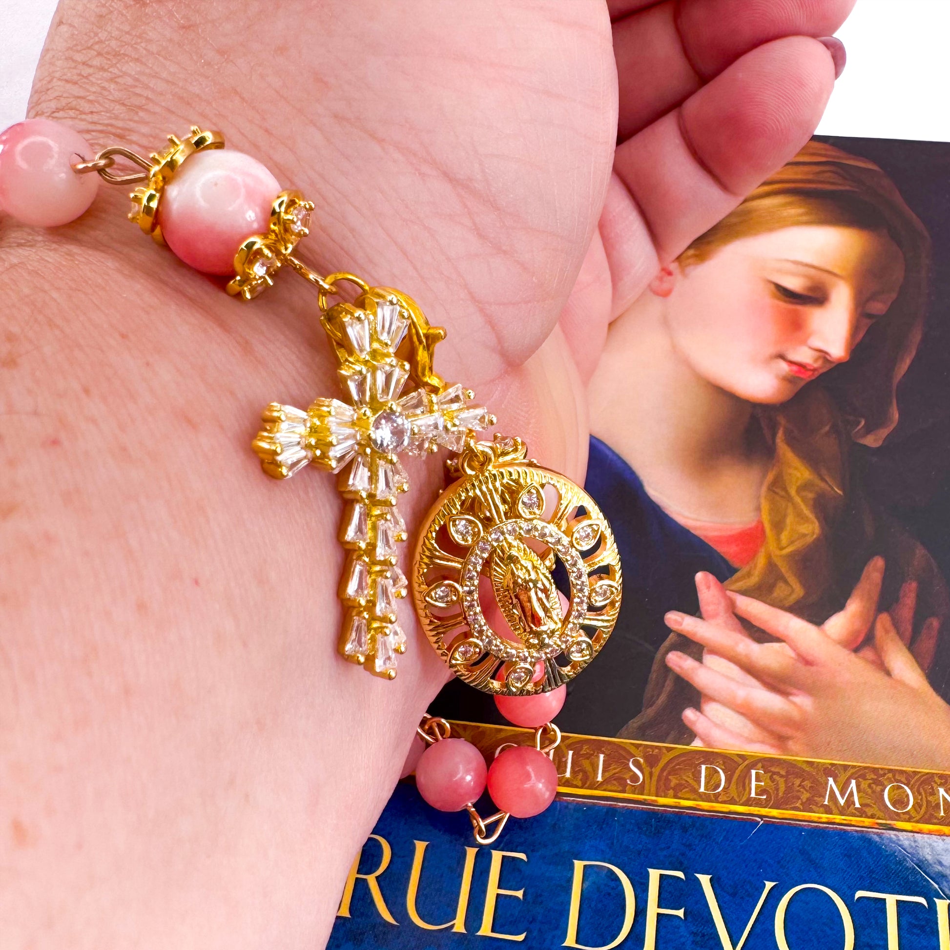 Luxury Catholic rosary bracelet handcrafted with natural pink persian jade gemstone beads, a gold-tone cross with zirconia accents, and a Lady of Guadalupe medal. Adjustable beaded bracelet perfect for prayer, religious gifts, Confirmation, bridesmaid gifts, or everyday devotion. Made in Edmonton, AB, Canada.