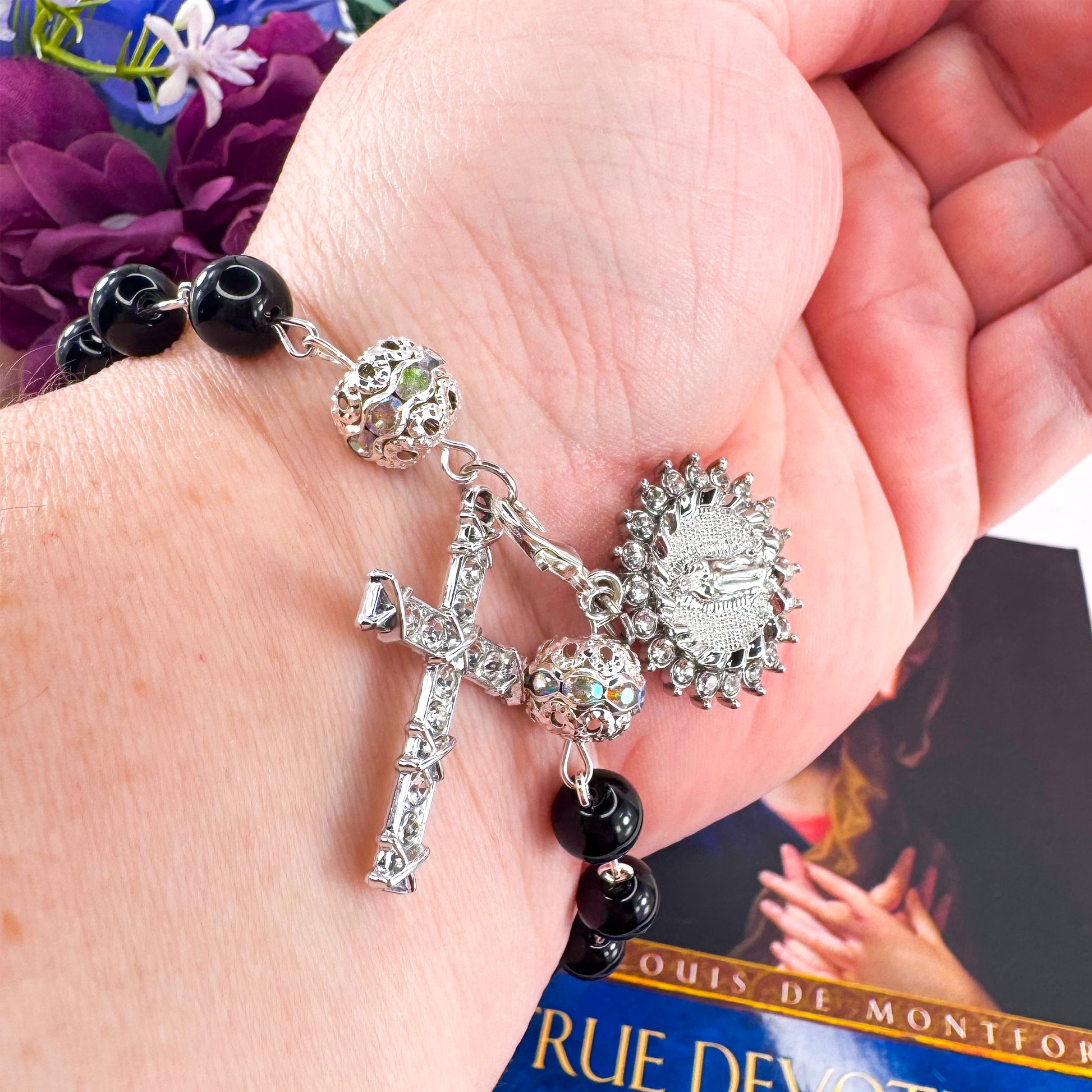 Luxury Catholic rosary bracelet handcrafted with natural black onyx gemstone beads, a silver-tone cross with zirconia accents, and a Lady of Guadalupe medal. Adjustable beaded bracelet perfect for prayer, religious gifts, Confirmation, bridesmaid gifts, or everyday devotion. Made in Edmonton, AB, Canada.