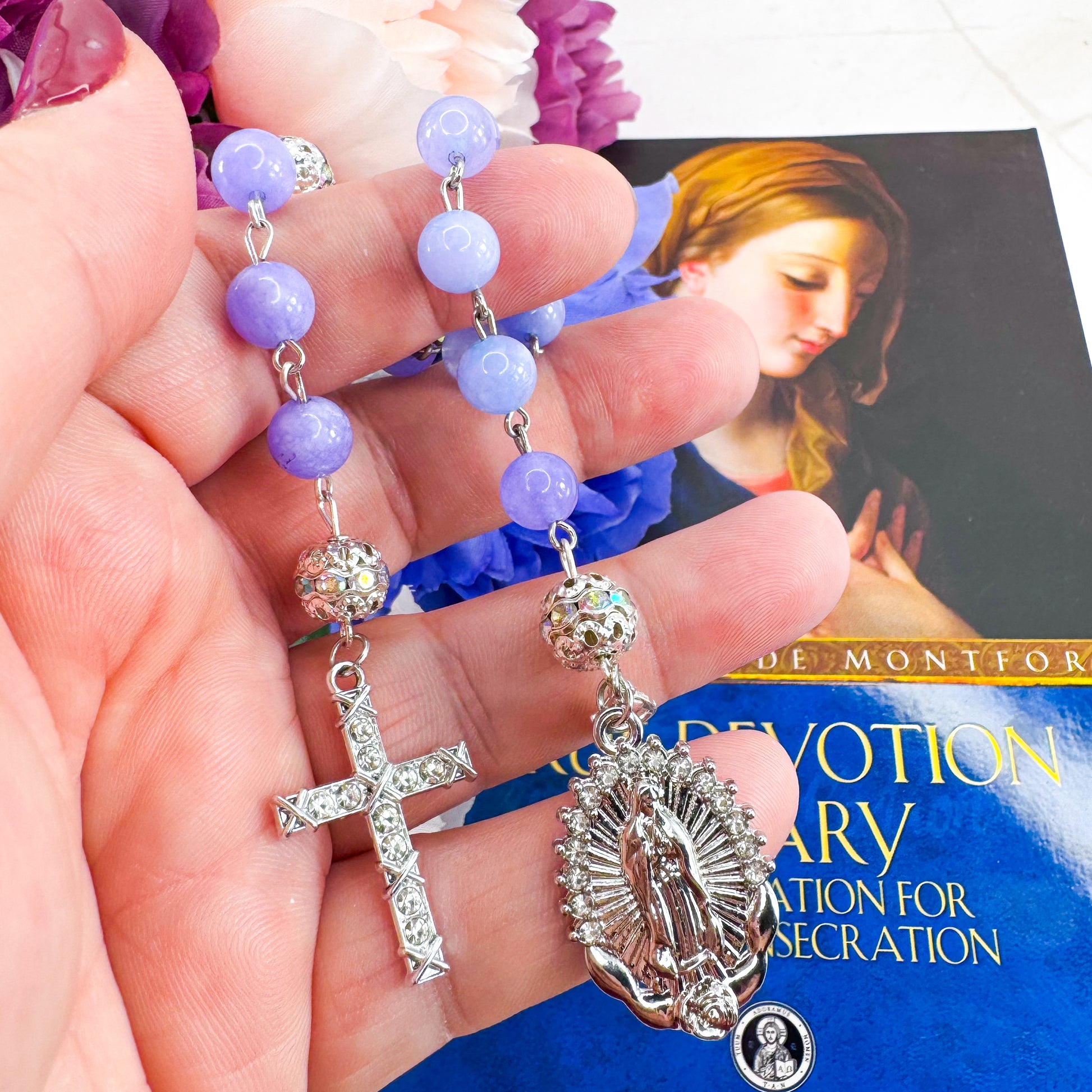 Luxury Catholic rosary bracelet handcrafted with natural Periwinkle Blue Angelite gemstone beads, a silver-tone cross with zirconia accents, and a Lady of Guadalupe medal. Adjustable beaded bracelet perfect for prayer, religious gifts, Confirmation, bridesmaid gifts, or everyday devotion. Made in Edmonton, AB, Canada.