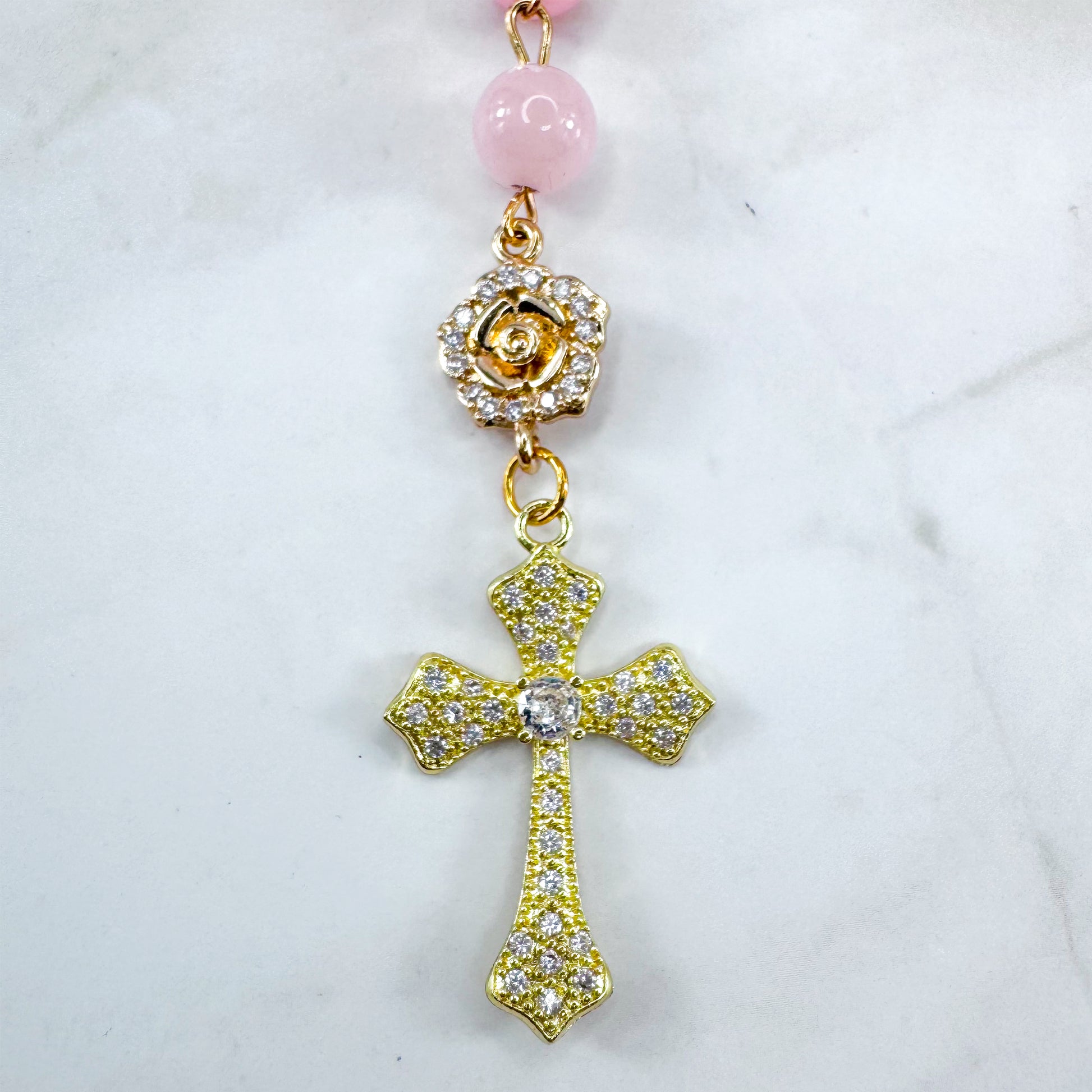 Luxury Catholic rosary bracelet handcrafted with natural rose quartz gemstone beads, a gold-tone cross with zirconia accents, and a Lady of Guadalupe medal. Adjustable beaded bracelet perfect for prayer, religious gifts, Confirmation, bridesmaid gifts, or everyday devotion. Made in Edmonton, AB, Canada.